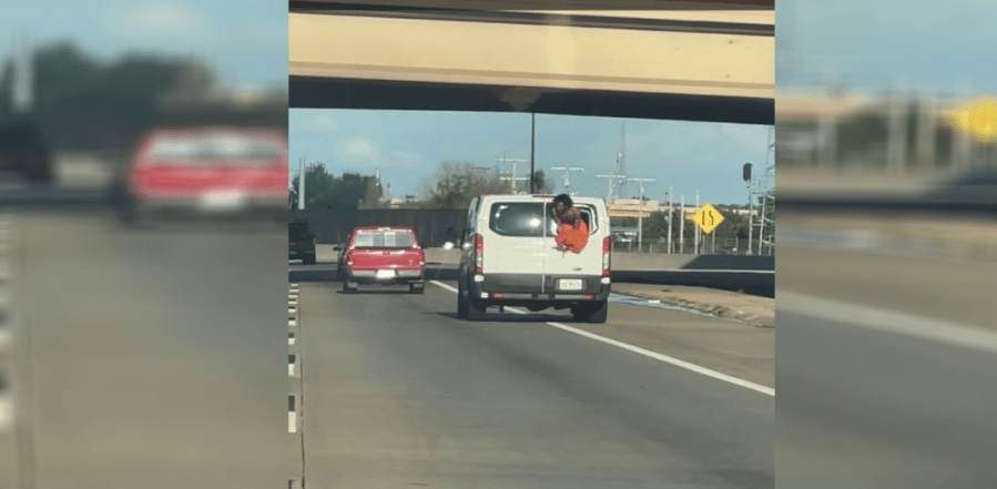 WATCH: Inmate hangs out of van on Oklahoma highway